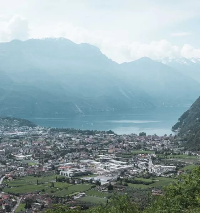 Riva del Garda from above, held between the lake and the mountains